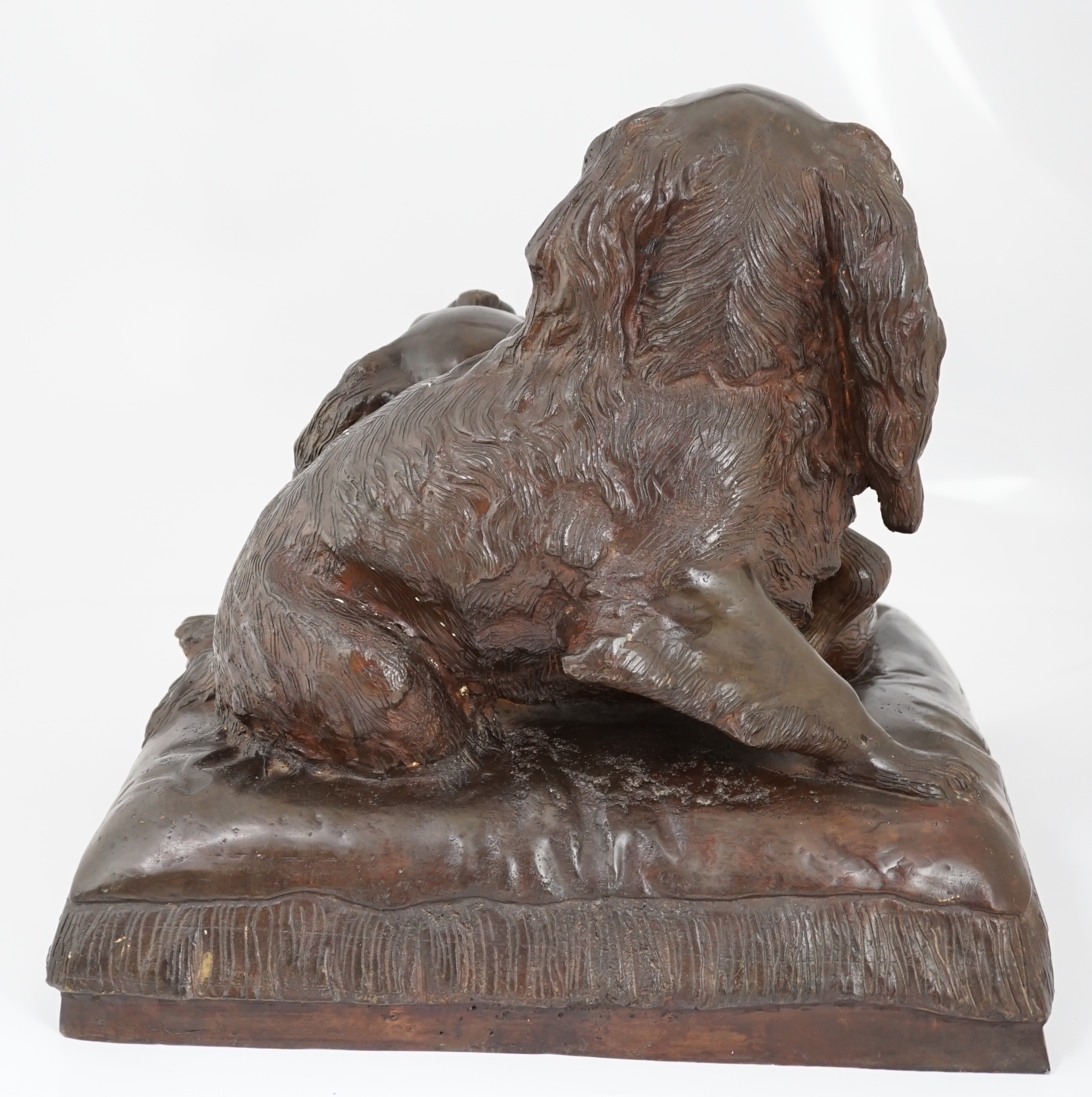 After Charles Valton (French, 1851-1819), a bronze group of two King Charles spaniels seated upon a cushion, 46cm wide, 42cm high